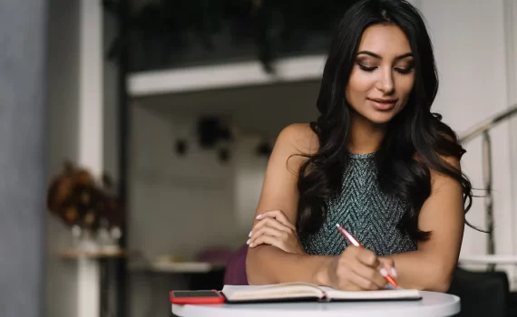 beautiful-indian-woman-taking-notes-working-from-home